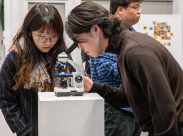 Two people look at an object