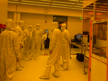Jorg Scholvin, associate director for Fab.nano, shows LAB14 representatives where the new VPG 300 DI maskless stepper will be positioned inside MIT.nano’s cleanroom.
